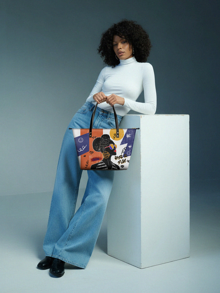 Woman holding a colorful tote bag against a gray background